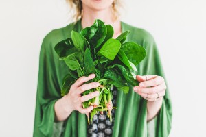 Young woman with fresh spinach